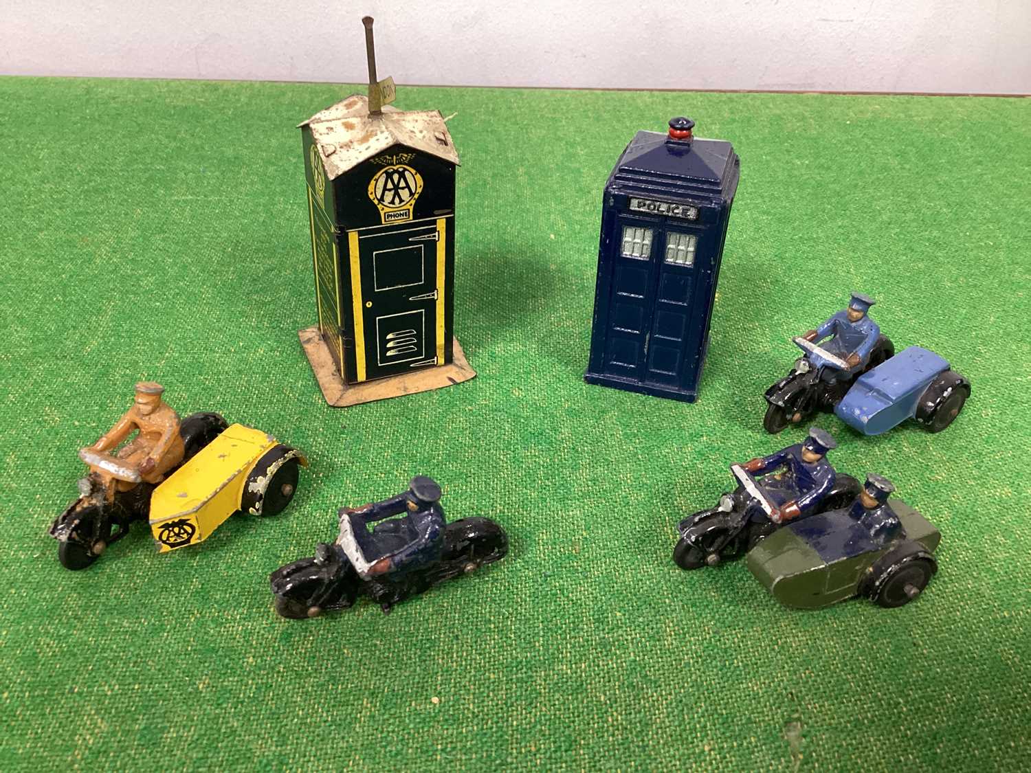 Four Post War Dinky Motorbikes, three with side car, AA/Police and RAC. Plus a Post War Police Box