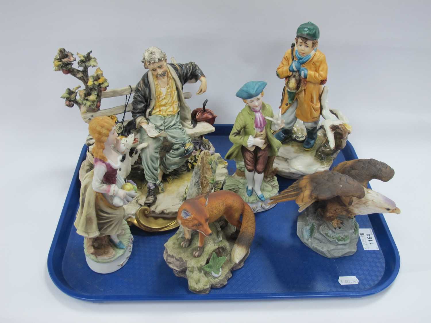 Capodimonte Tramp on Bench Figure Group, Young Hunter, Kowa Fox, Eagle and two foreign figurines (