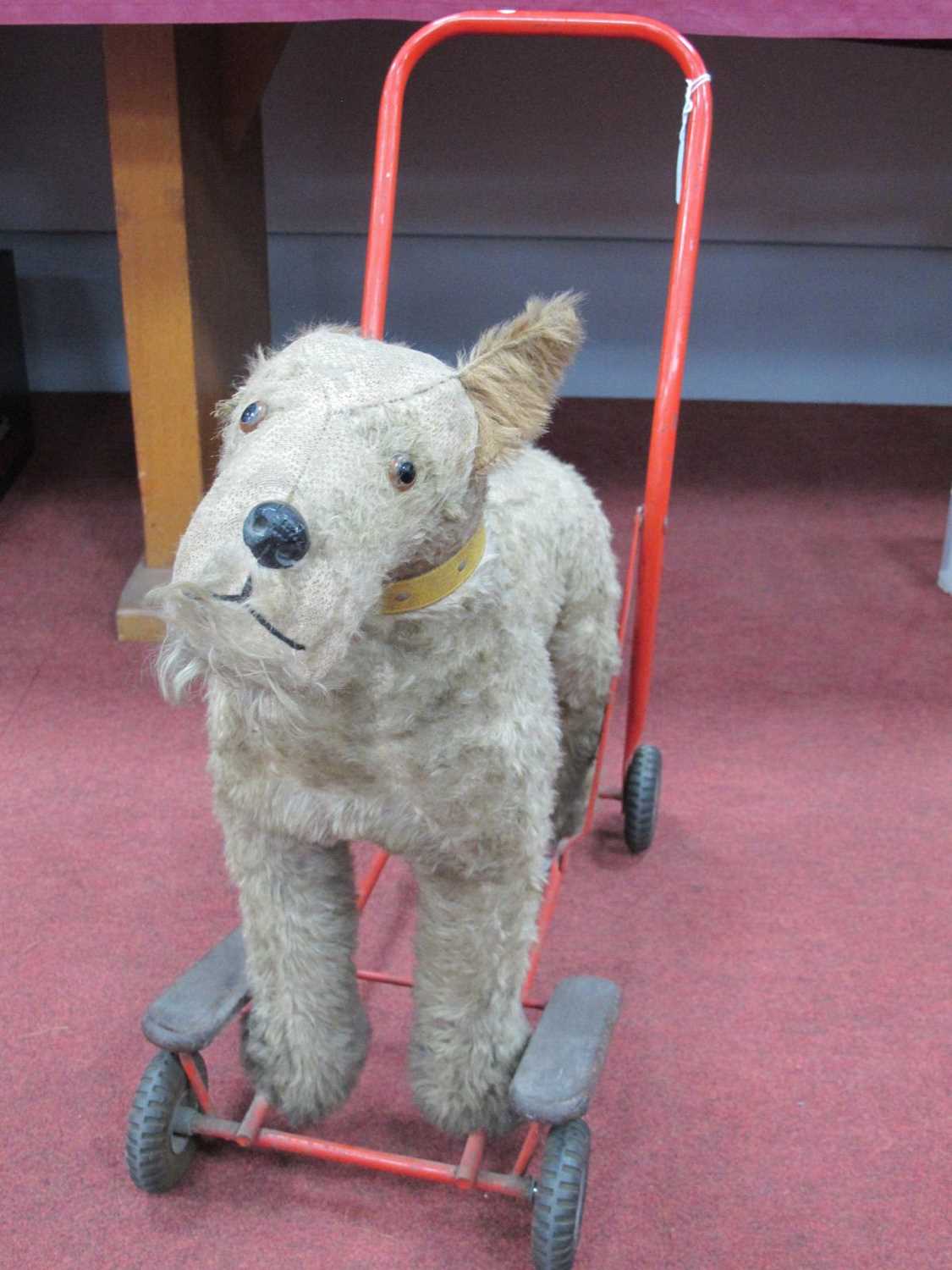 A push along dog made by Lines Bros. (Ireland) Ltd. On a metal frame with Tri-ang wheels.