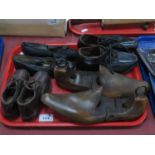 Two Pairs of Leather Child's clogs, a pair of girl's black leather shoes circa 1900 with bow