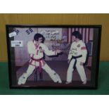 Photograph of Elvis Presley, with karate instructor Kang Rhee, dated 1989 and signed by Khan Rhee (