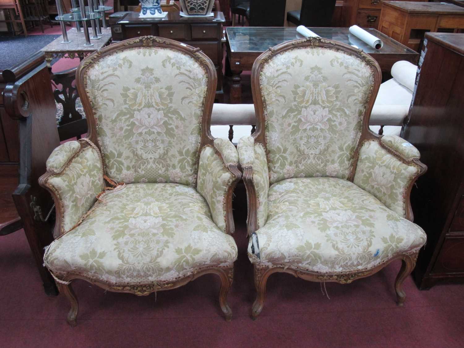 Pair of French Style Walnut Framed Easy Chairs, with scroll and floral carving, carbriole legs,