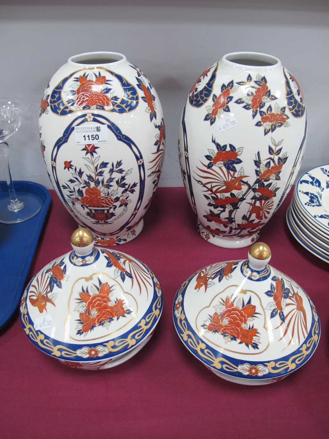 Pair of Panda Lidded Vases, with stands in Imari colours featuring foliage with birds in flight,