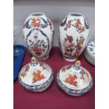 Pair of Panda Lidded Vases, with stands in Imari colours featuring foliage with birds in flight,