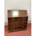 An XVIII Century Oak Bureau, with fall front and fitted interior above four long drawers, on bracket