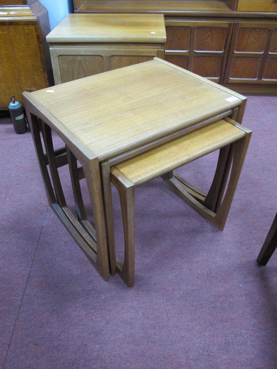 E. Gomme, a teak nest of coffee tables, circa 1970's with rectangular tops and barrel-shaped