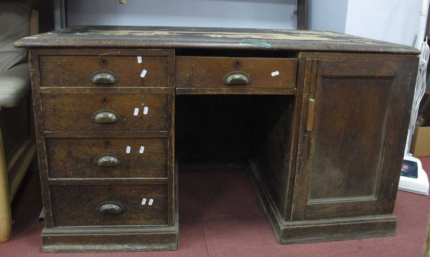 Late XIX Century Oak Pedestal Desk, with a crossbanded top, flanking pedestals, with a cupboard