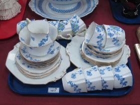 A Stafford Bone china Tea Service, decorated with forget-me-nots with floral molded handles:- One