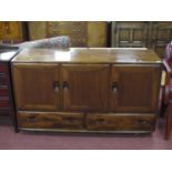 Ercol Sideboard, with oval handles to three cupboard doors and two lower drawers, on Shepherds