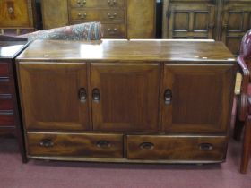 Ercol Sideboard, with oval handles to three cupboard doors and two lower drawers, on Shepherds
