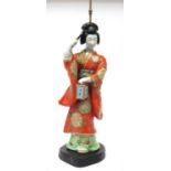 Oriental Pottery Table Lamp as a Geisha Girl, holding a fan in her right hand and lantern in the