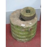 A Stone Millstone, 35cm wide; together with a smaller stone, 18cm wide. (2)