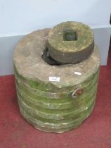 A Stone Millstone, 35cm wide; together with a smaller stone, 18cm wide. (2)