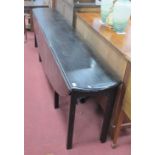 XVIII Century Style Ebonised Wake Table, with drop leaves on square supports, 256cm wide.