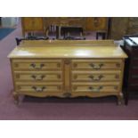 A French Style Oak Chest of Drawers, with moulded edge over six small drawers on scroll feet,