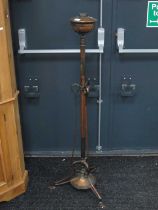 An early XX Century copper standard oil lamp with cylindrical support, hooked brackets on circular