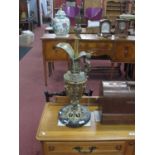 A Gilded Brass Table Lamp, in the form of a Ewer, on a grey marble circular base, 75cm high.