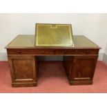A XIX Century Mahogany Partners Desk, with crossbanded top inset with green leather sciver, hinged