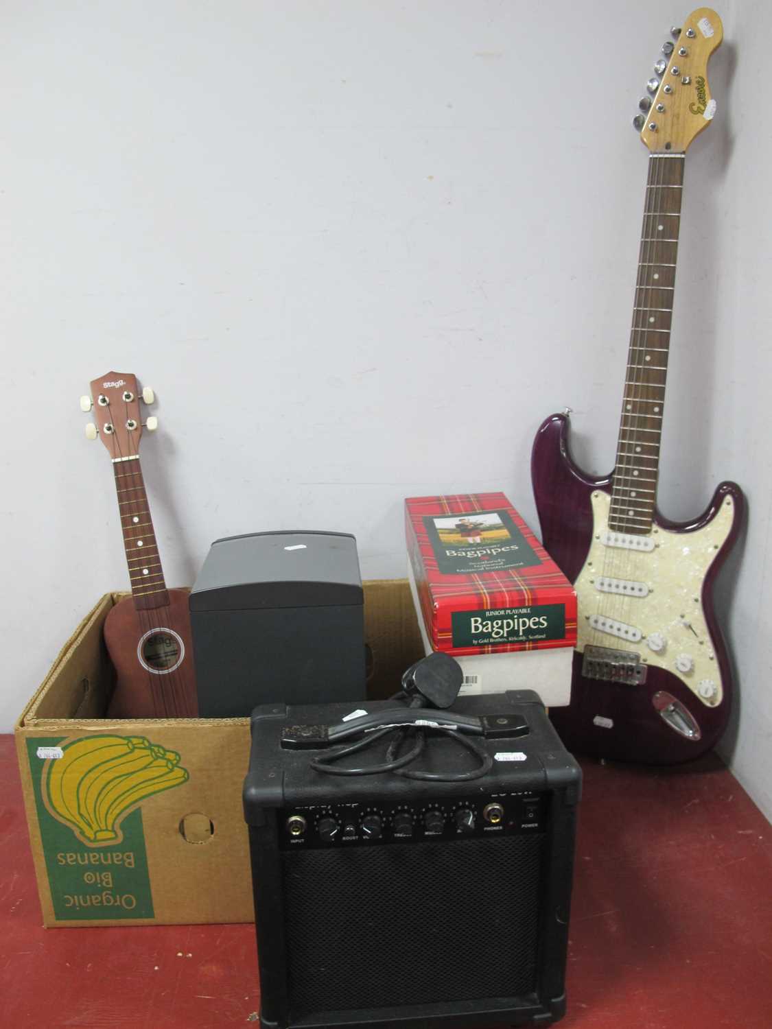 An Encore electric base guitar, Bose companion 3 series II speaker, Dispaly4Top guitar amp,
