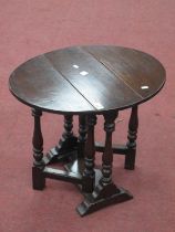 An Oak Occasional Table, with drop leaves on turned and block supports, 60cm wide, 50cm high.