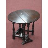 An Oak Occasional Table, with drop leaves on turned and block supports, 60cm wide, 50cm high.