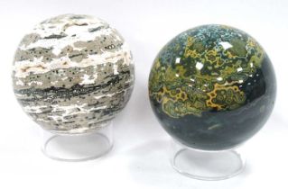 Moss Agate Sphere, on a stand, together with a quartz sphere on a stand (2).