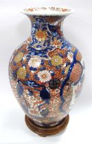 Oriental - A Japanese Imari baluster vase decorated in reds, blues and gilt with flowers, trees