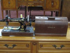 An Early XX Century Singer Hand Sewing Machine, with gilt decoration and domed cover, with key.