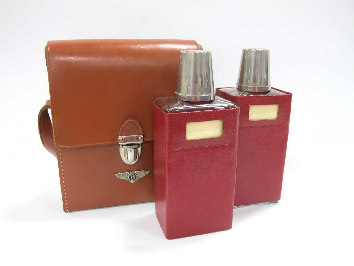 An Art Deco Bentley hide motoring drinks case containing two glass decanters with two plated - Image 3 of 3