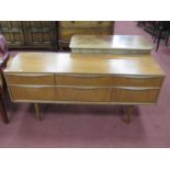 1970's Teak Sideboard, with full length handles to three flights each of two drawers, on tapering