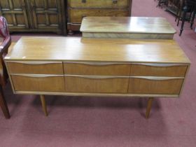 1970's Teak Sideboard, with full length handles to three flights each of two drawers, on tapering