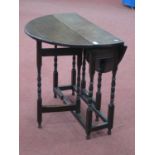 XVIII Century and Later Joined Oak Gateleg Table, with drop leaves on bobbin and block supports,