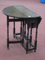 XVIII Century and Later Joined Oak Gateleg Table, with drop leaves on bobbin and block supports,