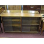 Pair of Teak Book Cases, circa 1970's with inner shelves and glass sliding doors, 136cm wide (2)