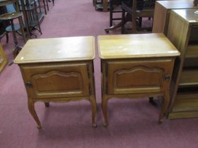 A Pair of French Style Oak Bedside Cabinets, the tops with moulded edge, panelled cupboard doors