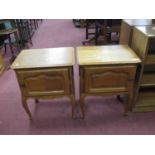 A Pair of French Style Oak Bedside Cabinets, the tops with moulded edge, panelled cupboard doors