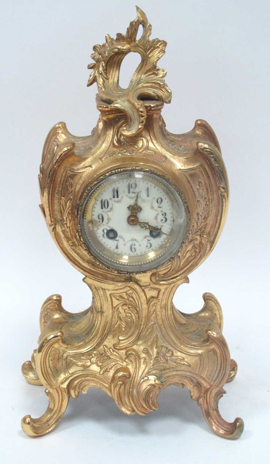 A Late XIX Century French Mantle Clock, the ornate ormolu case cast with scrollwork and flowers, the