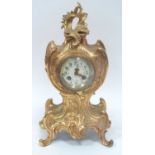 A Late XIX Century French Mantle Clock, the ornate ormolu case cast with scrollwork and flowers, the