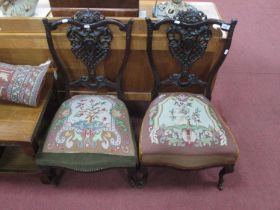A Pair of Late XIX Century Ebonized Nursing Chairs, each with lattice pierced splat, on cabriole