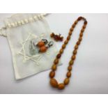 An Amber Coloured Graduated Bead Necklace, the knotted beads to barrel style clasp, together with an