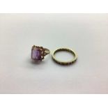 A 9ct Gold Stone Set Ring, the princess cut centre stone, to four claw setting, between shoulders of