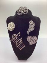 Modern Costume Brooches, on black display bust.