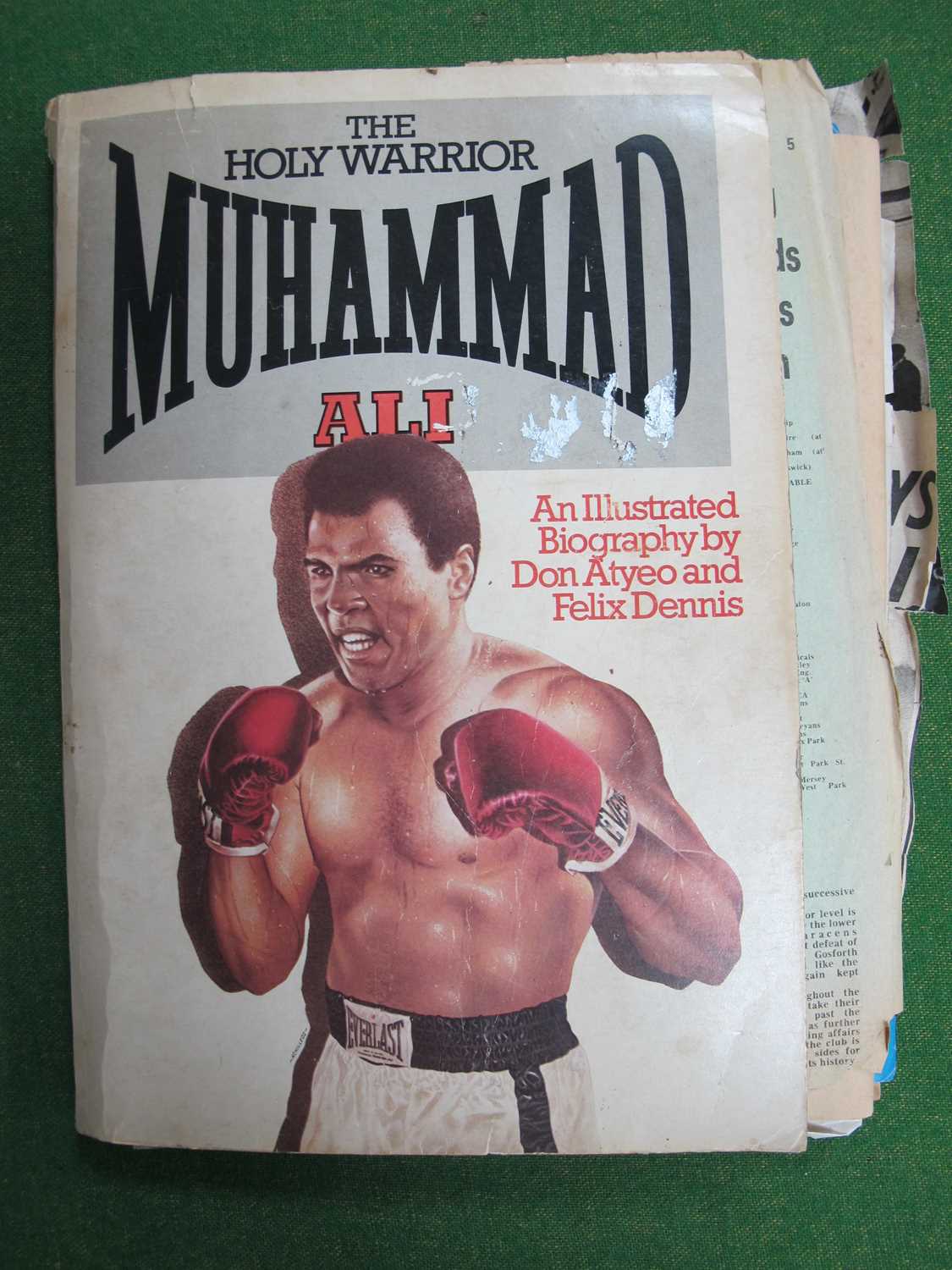 Boxing - Muhammad Ali Biography, by Atyeo and Dennis with loose newspaper and magazine articles.