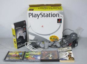 An Original Sony PlayStation (PS1) Gaming Console, Controllers, Cables, Literature, Three PS1