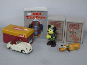 Two Modern Retro Toy Tinplate Clockwork Disney Figures, a modern Schuco sport examico and a book