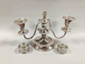 A Barker Ellis Twin Branch Dwarf Candelabrum, together with two hallmarked silver napkin rings.