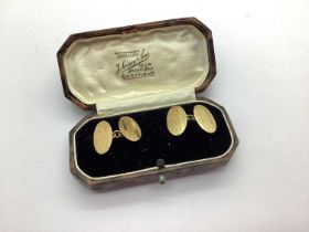 A Pair of Chester Hallmarked 9ct Gold Cufflinks, the engine turned oval panels on chain