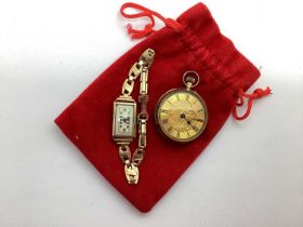 A Decorative Fob Watch, the scroll engraved dial with black Roman numerals, within engraved case (