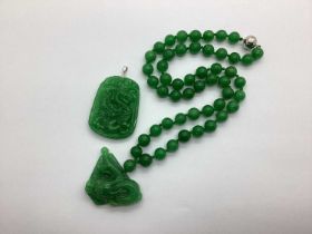 A Modern Green Jade Bead Necklace, to magnetic clasp, suspending dragon design panel pendant;