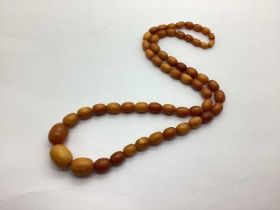 An Amber Coloured Graduated Single Strand Bead Necklace, approximately 68cm.